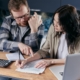 A man and a woman looking at a document